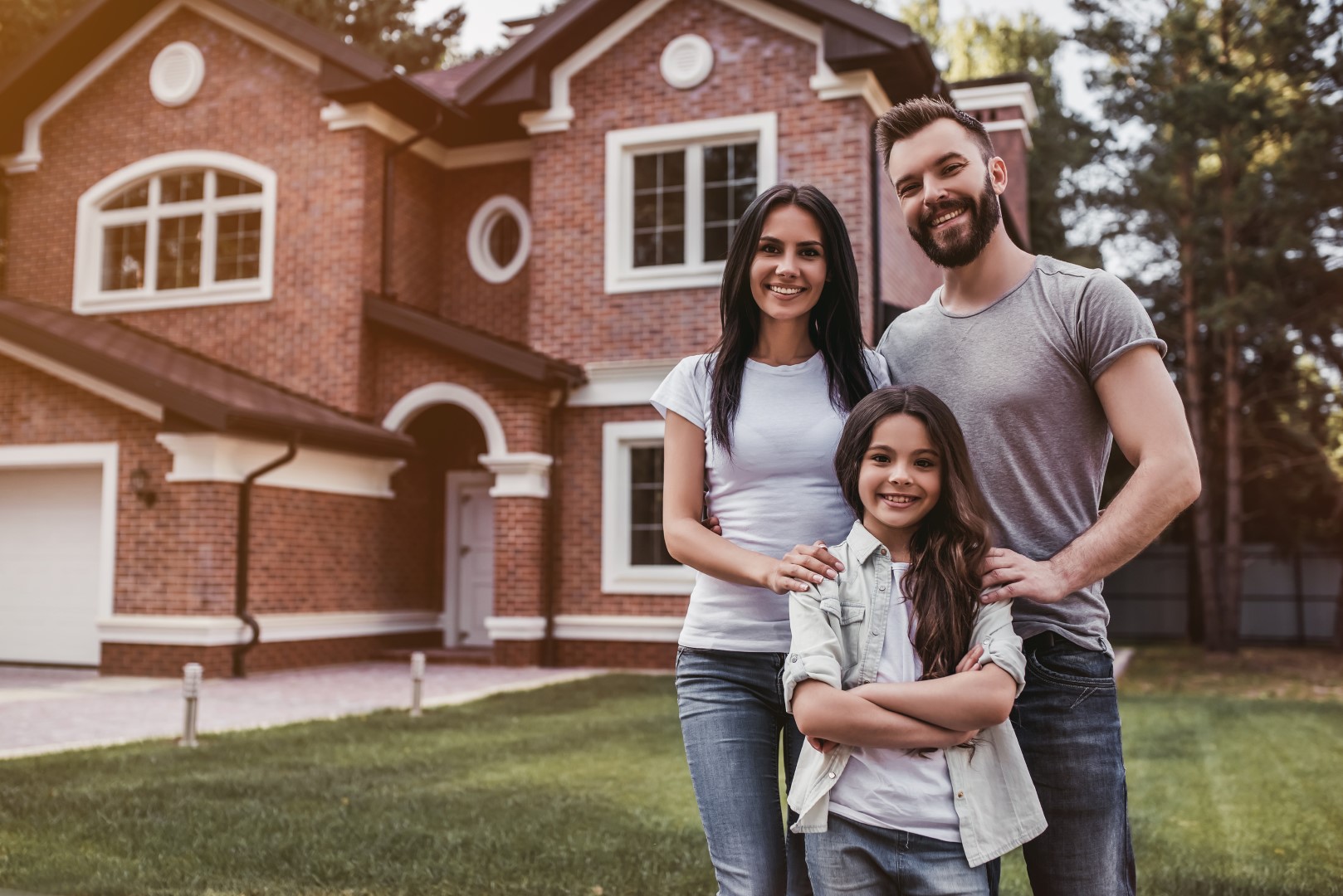 Happy Family in Front of New Home